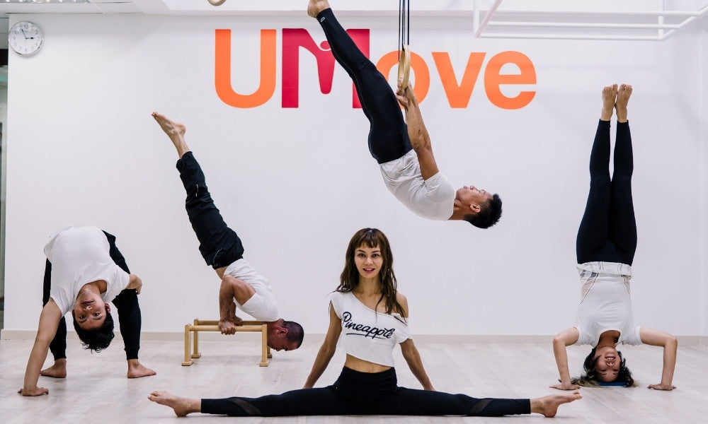 UMove team members showing shoulder stand, front lever, head stand, bridge and side split exercises