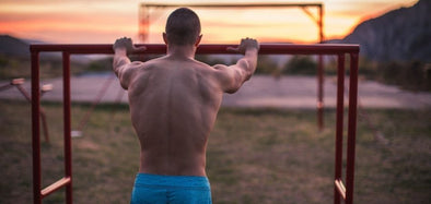 man showing back muscles after doing bar workout in Calisthenics