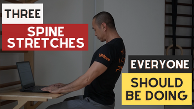 seated on a work desk trying to stretch the spine: 3 spine stretches everyone should be doing