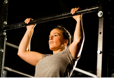 Lady demonstrating pull up on a bar
