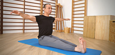 Michel Velasco demonstrating Pilates Spine twist exercise on the mat